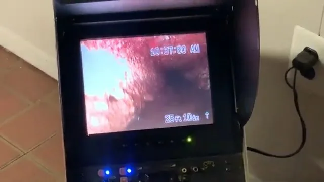 Camera monitor showing the inside of a drain pipe with a distance readout of 25 feet